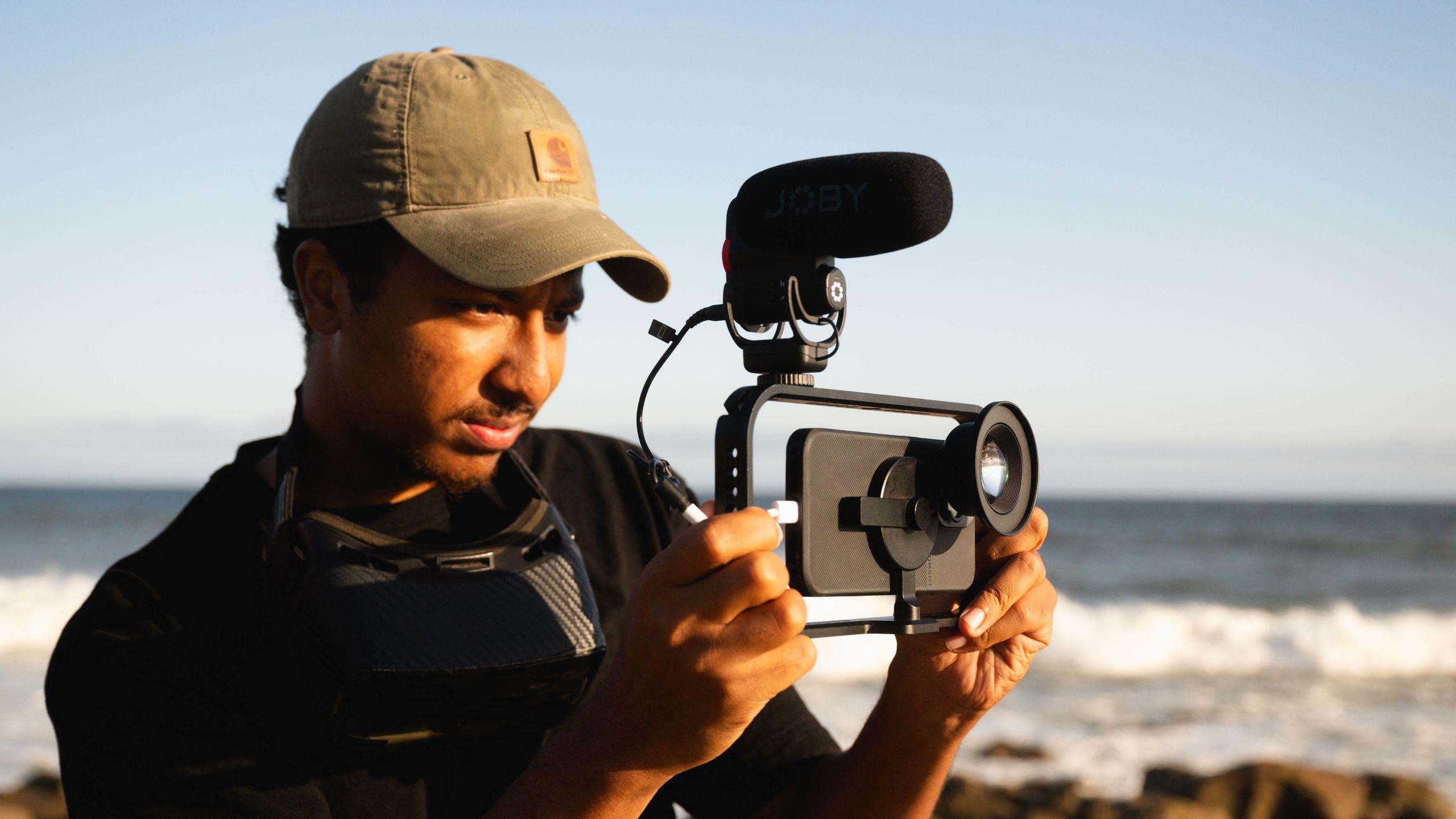 Man shooting a mobile rig with microphone on the beach